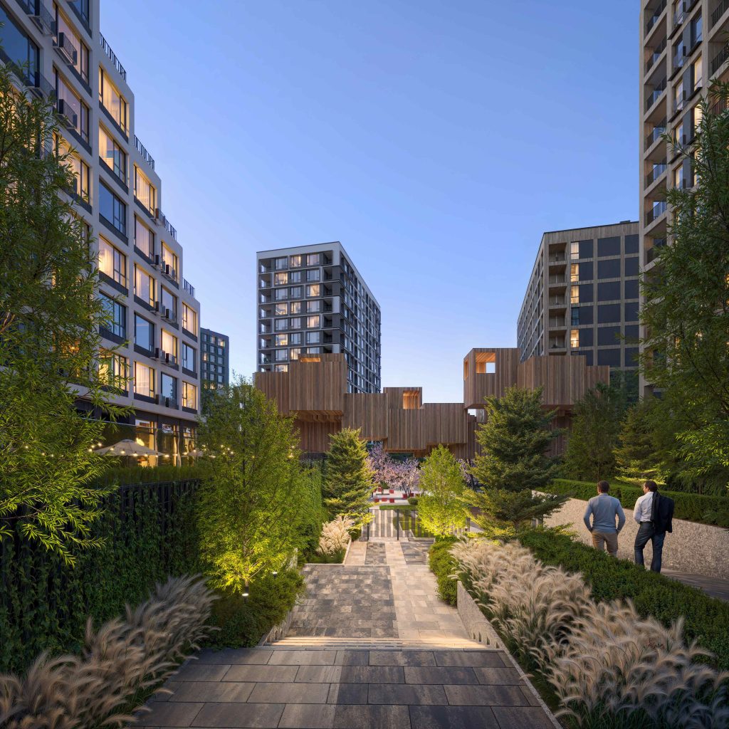 Pedestrian boulevard between residential blocks: paved walkway, layered planting, ground-level lighting