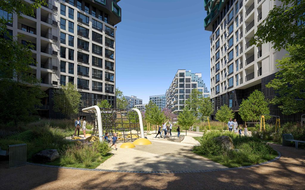 DNIPRO ISLAND courtyard between towers: the playground in sun, the foreground in the shadow of a building