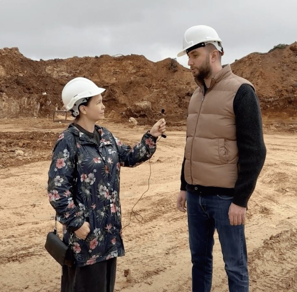 Construction site at the earthworks stage, two people in hard hats
