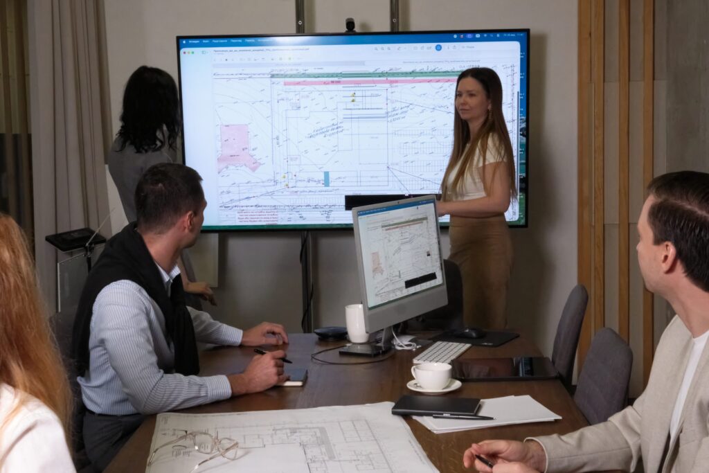 Meeting at a screen showing a drawing in the AIMM office